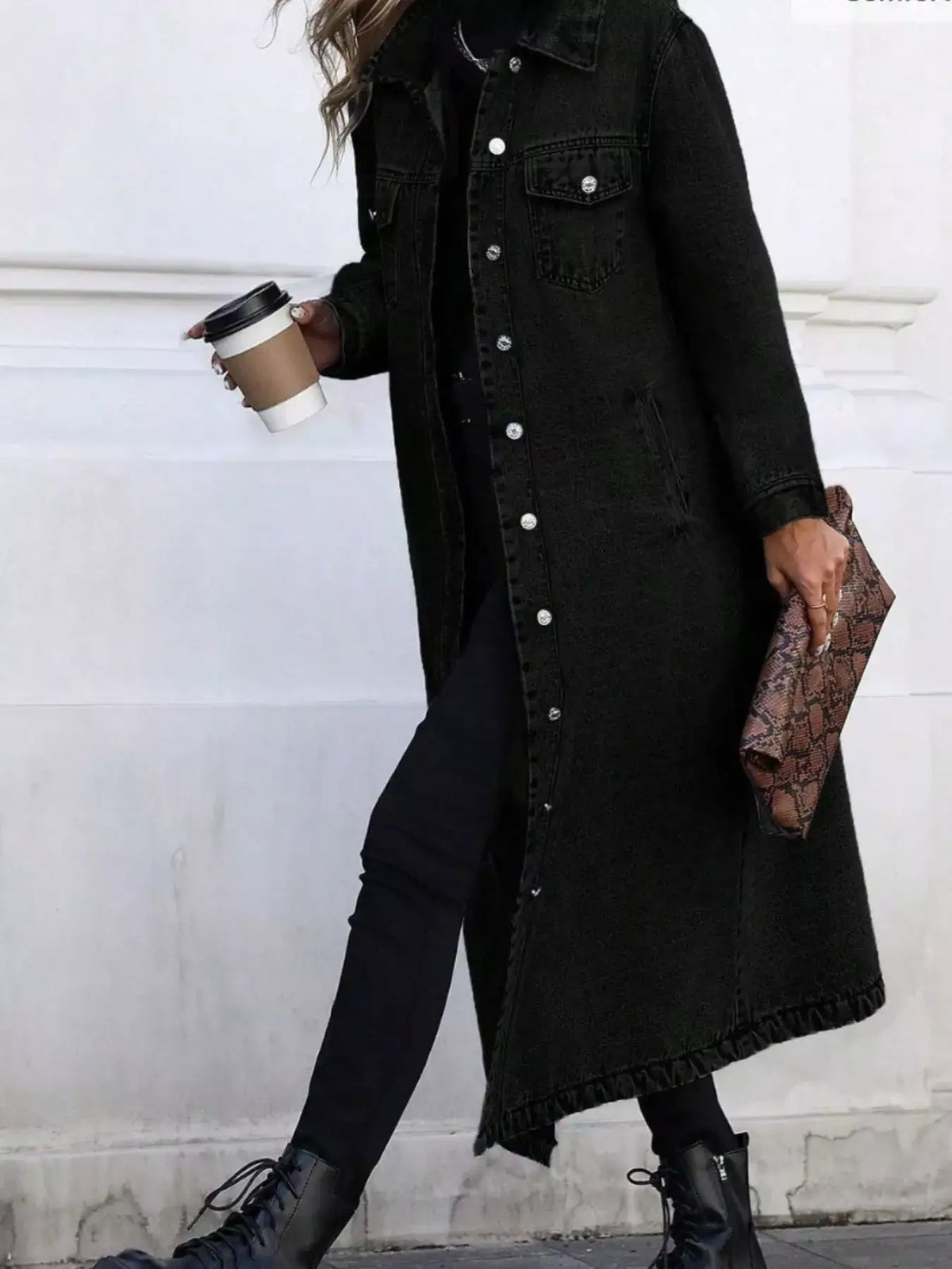 Woman wearing a black longline button-front denim jacket from Evie's Dreamland with black skinny jeans.