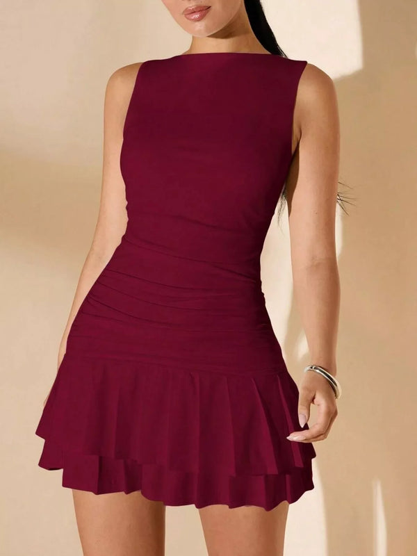 Woman wearing sleeveless burgundy mini dress with layered ruffle skirt and silver bracelet