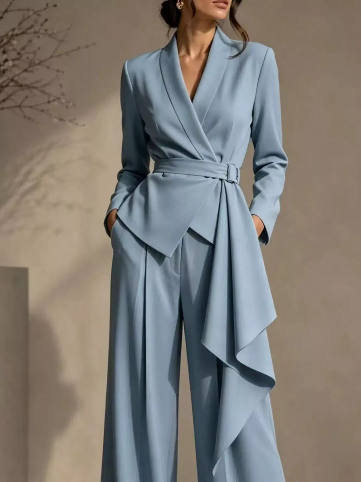 Light blue Evie's Dreamland belted blazer and wide-leg pants set with a draped waist detail.