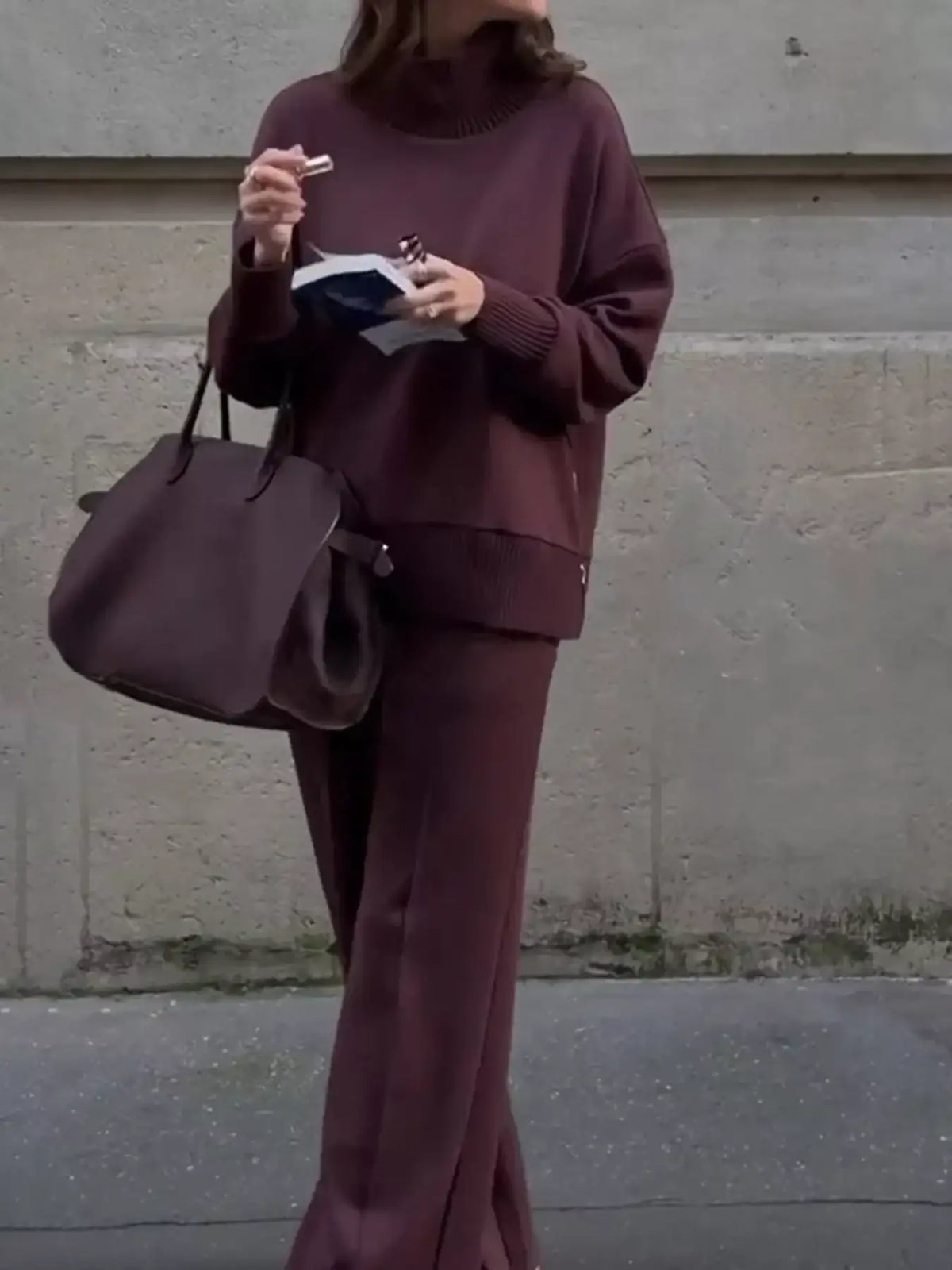 Woman wearing a plum ribbed turtleneck sweatshirt and matching wide-leg pants set from Evie's Dreamland.