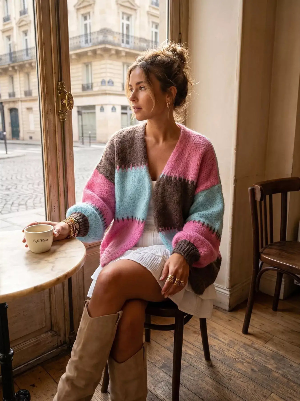 Woman wearing an Evie's Dreamland color-block v-neck cardigan with pink, blue, and brown stripes.