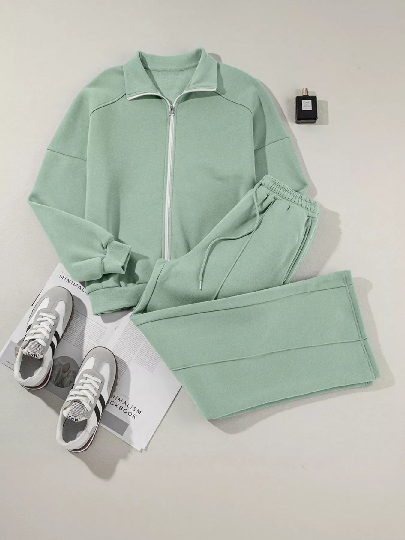 Mint green fleece zip-up jacket and matching jogger pants with white sneakers and perfume bottle
