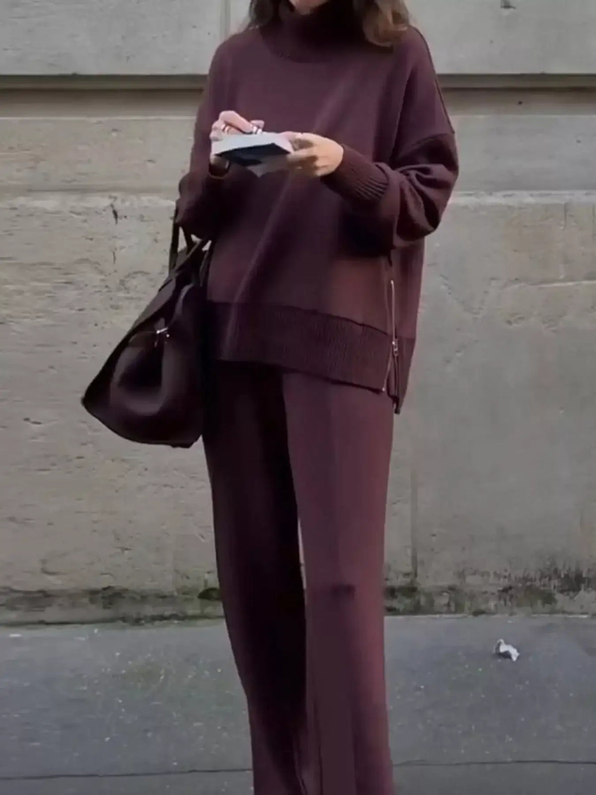 Woman wearing a plum ribbed sweatshirt and wide-leg pants set from Evie's Dreamland.
