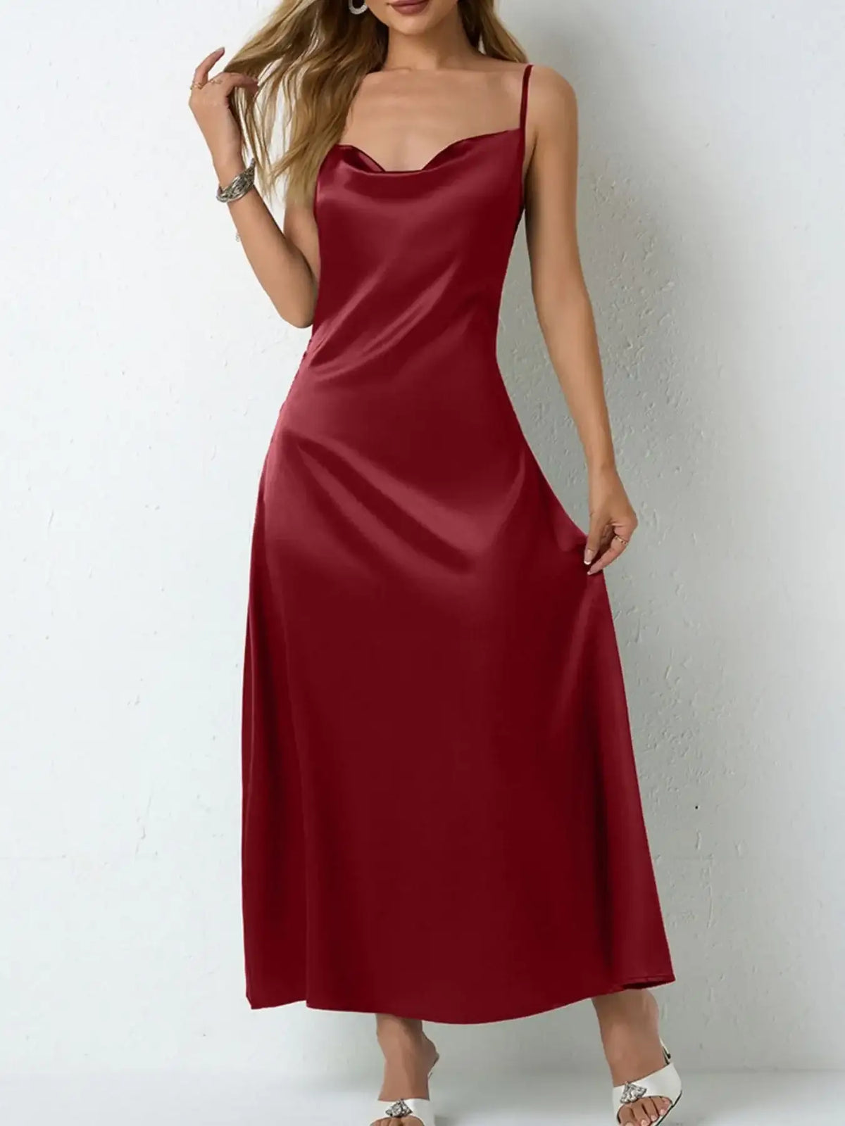 Woman wearing an Evie's Dreamland red satin cowl neck slip maxi dress.