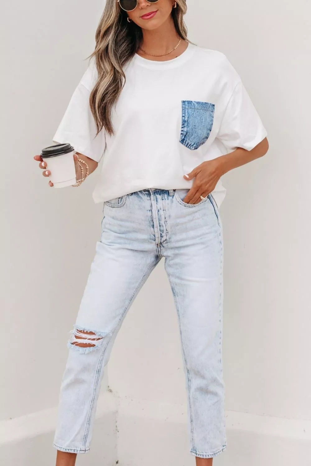 White oversized t-shirt with denim pocket paired with light wash ripped jeans, casual everyday fashion