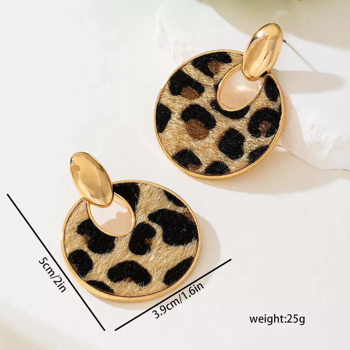 Evie's Dreamland 18K gold-plated circle dangle earrings with a leopard print pattern.