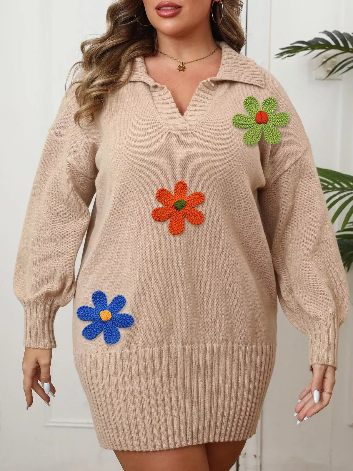 Beige Evie's Dreamland plus size sweater dress with floral appliqués, V-neck, and ribbed hem.