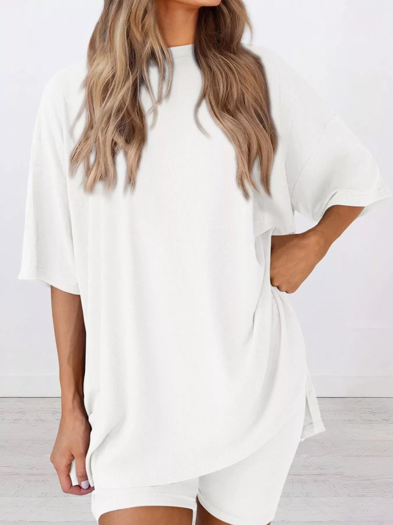 Woman wearing oversized white lounge t-shirt and shorts set, casual comfy outfit