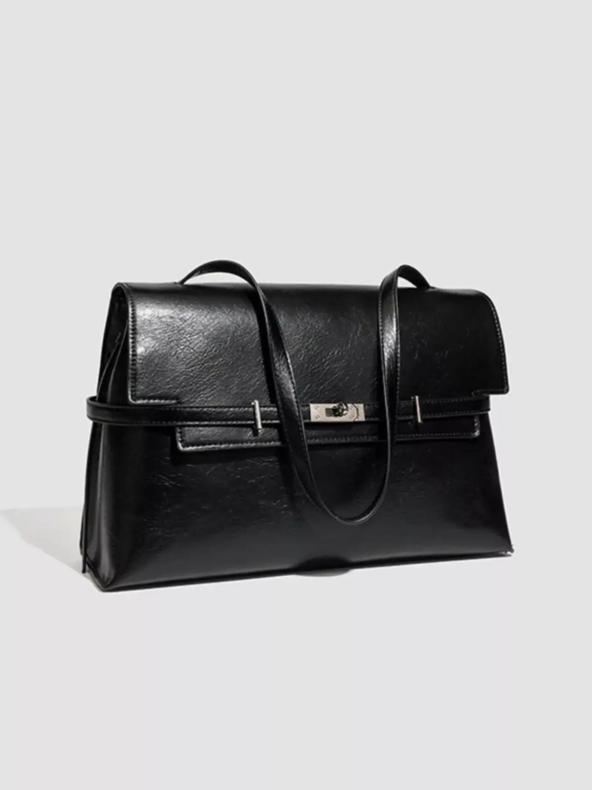 Evie's Dreamland black medium PU leather shoulder bag with a buckle closure and sleek finish.