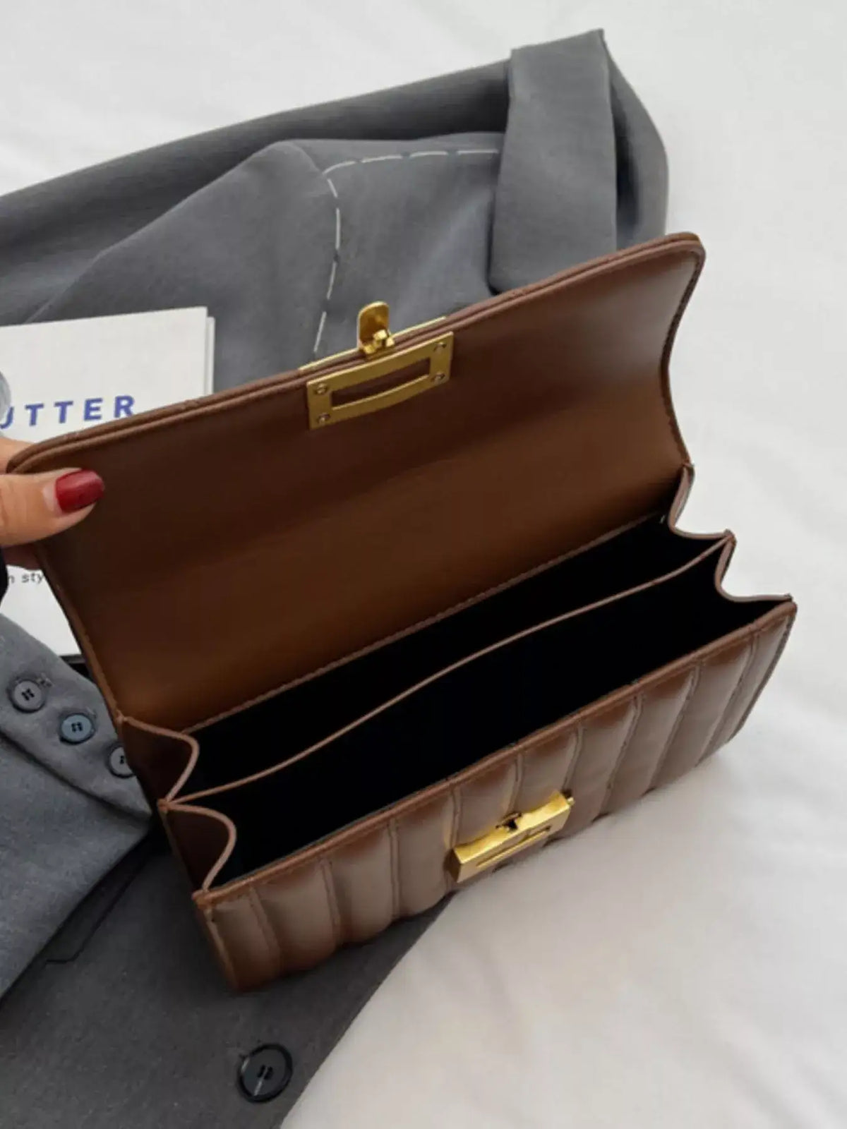 Open brown quilted PU leather flap shoulder bag by Evie's Dreamland with gold-tone clasp.