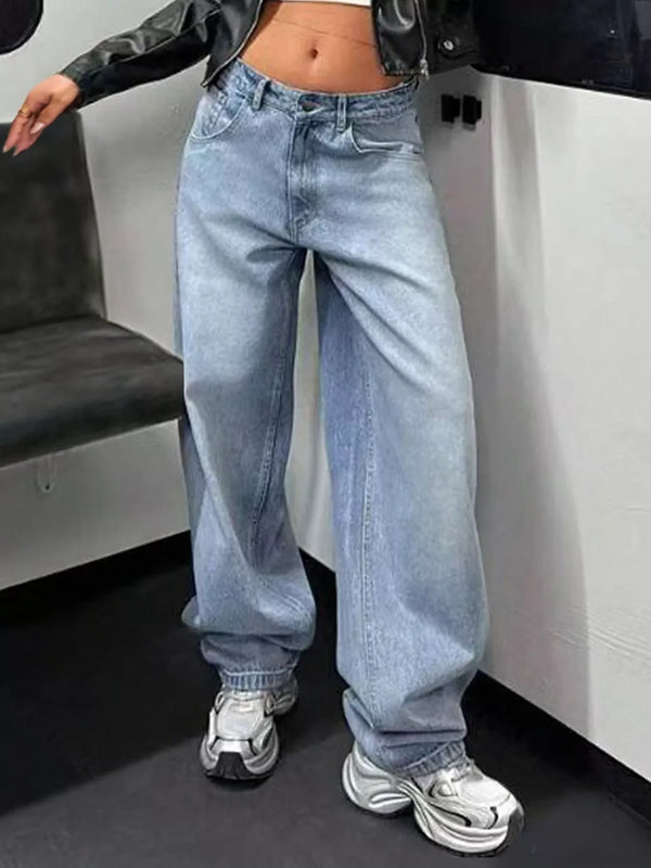 Woman wearing high-waisted wide leg light wash jeans and chunky sneakers indoors
