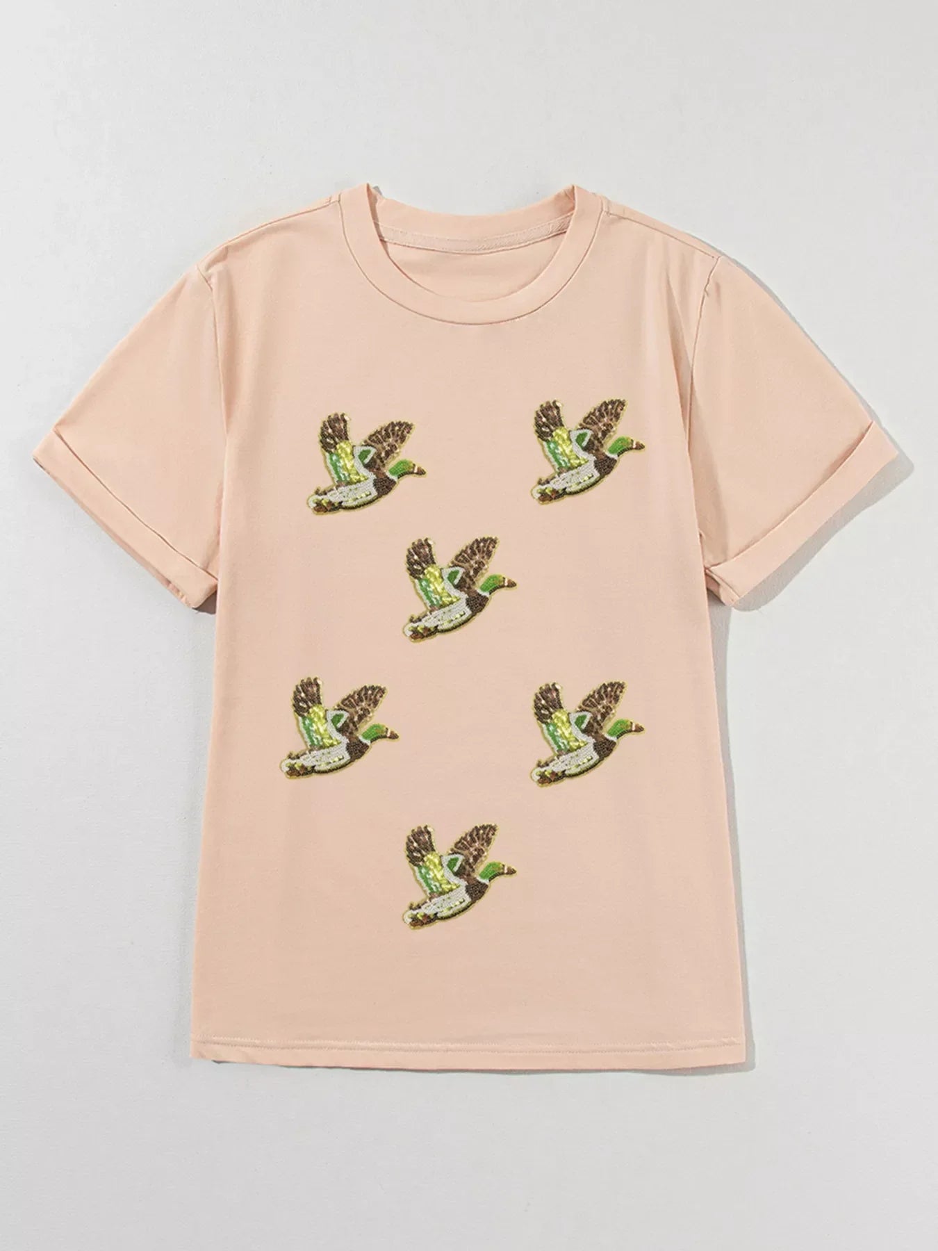 Light pink short sleeve t-shirt with embroidered flying green and brown mallard duck patches