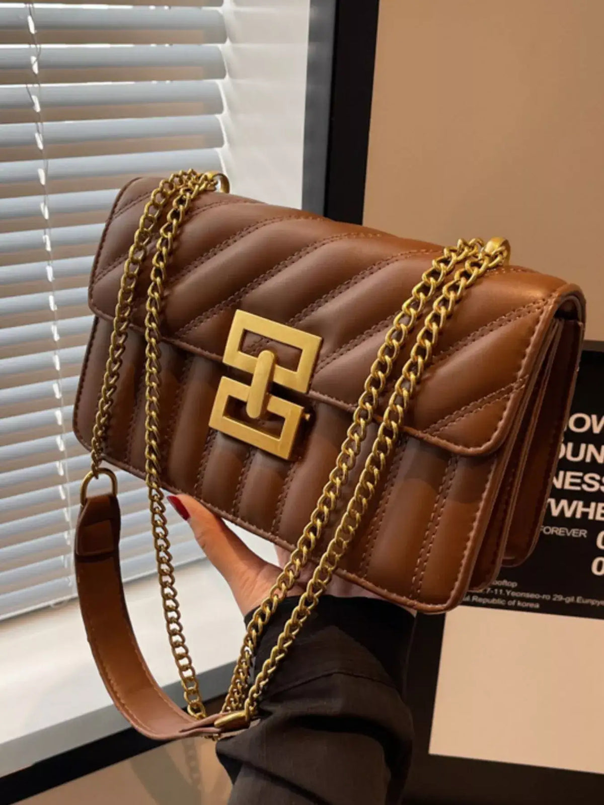 Brown quilted PU leather flap shoulder bag by Evie's Dreamland with a gold clasp and chain strap.