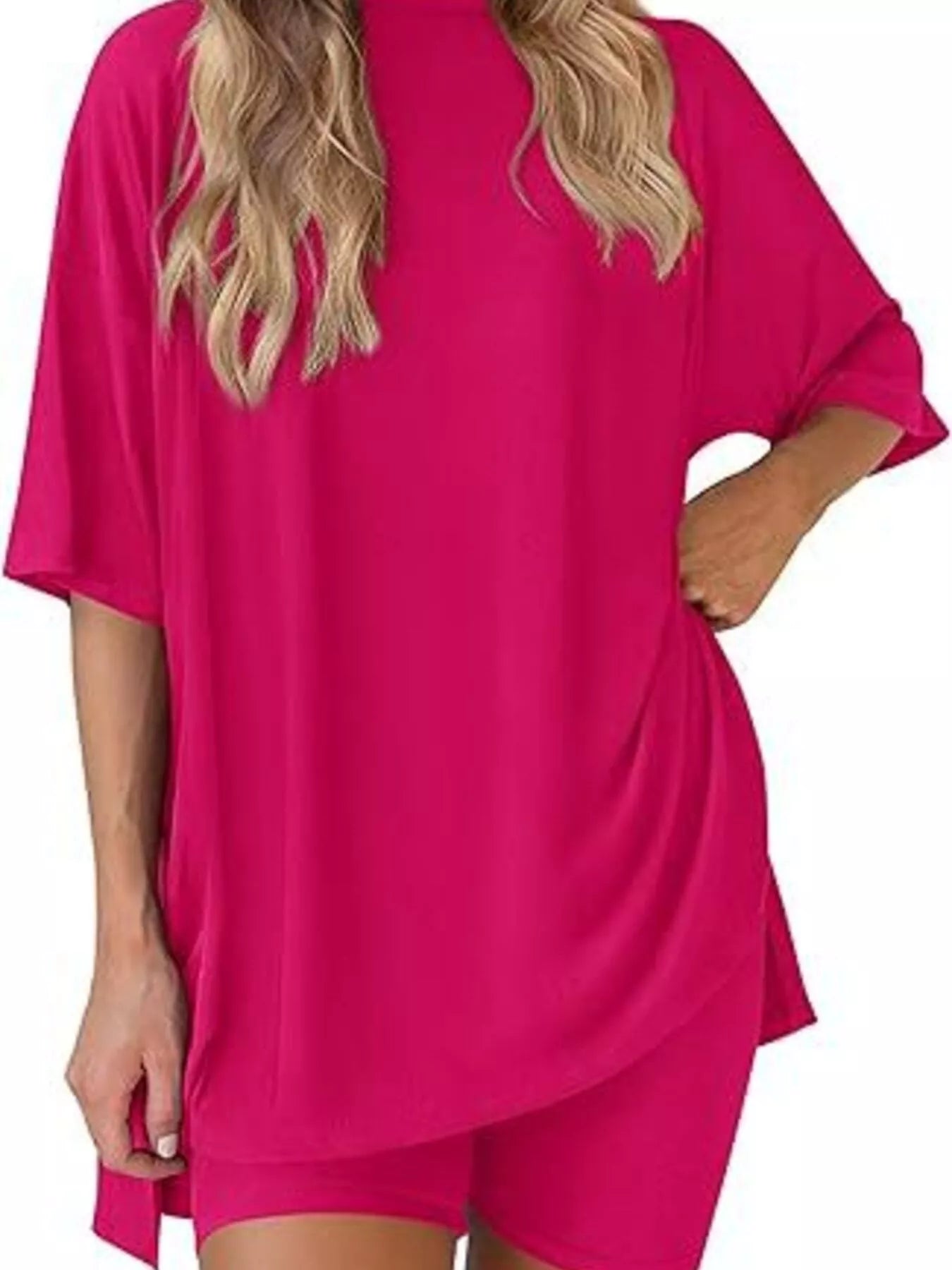 Woman wearing hot pink oversized lounge t-shirt and matching shorts set