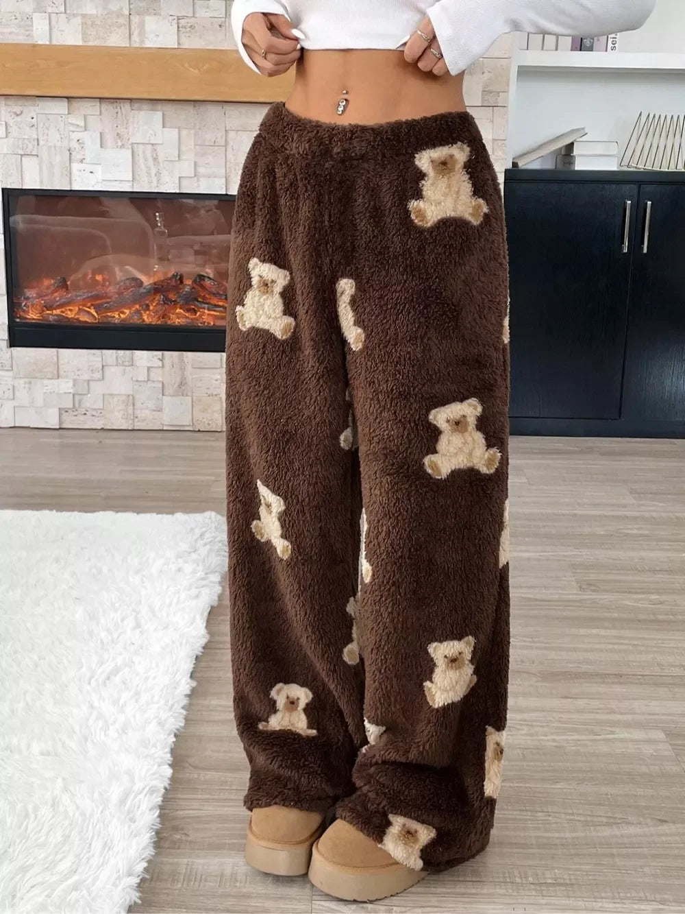 Cozy brown fleece pants with cream teddy bear patterns worn indoors by model at Evie's Dreamlands