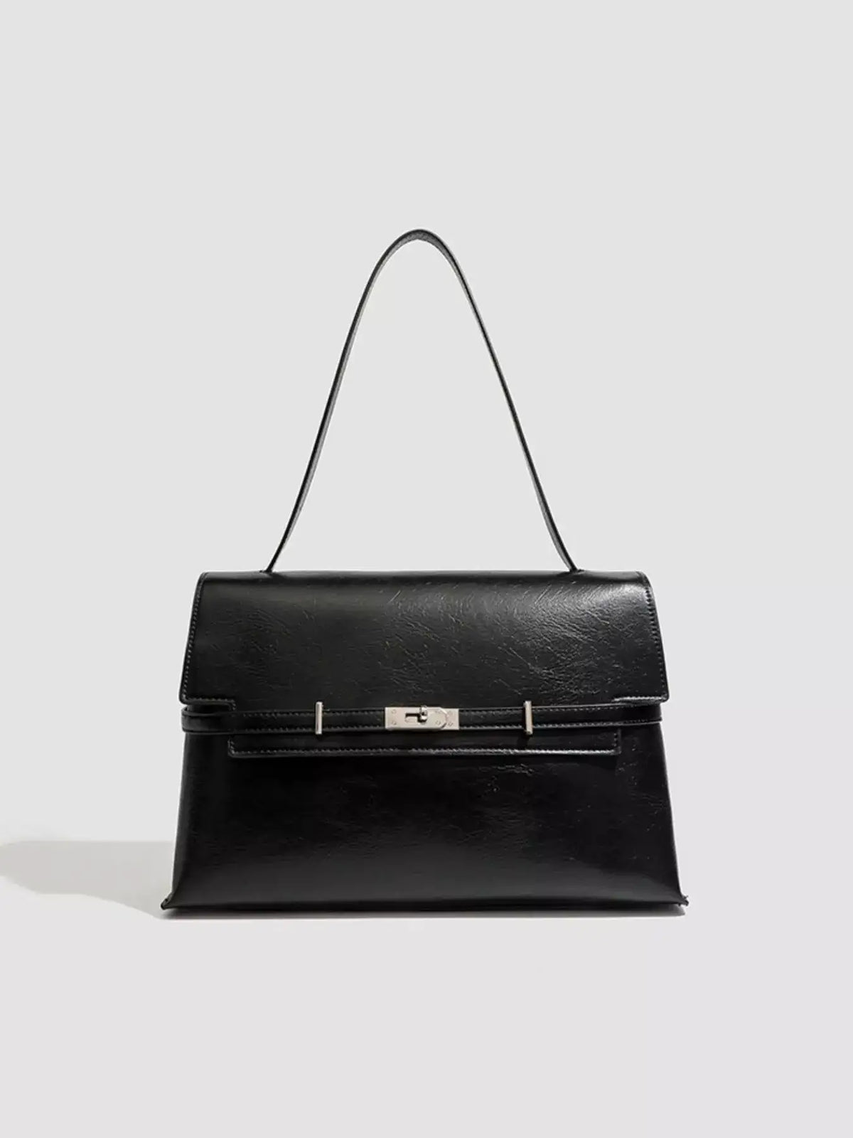 Evie's Dreamland black medium PU leather shoulder bag with a silver buckle closure.