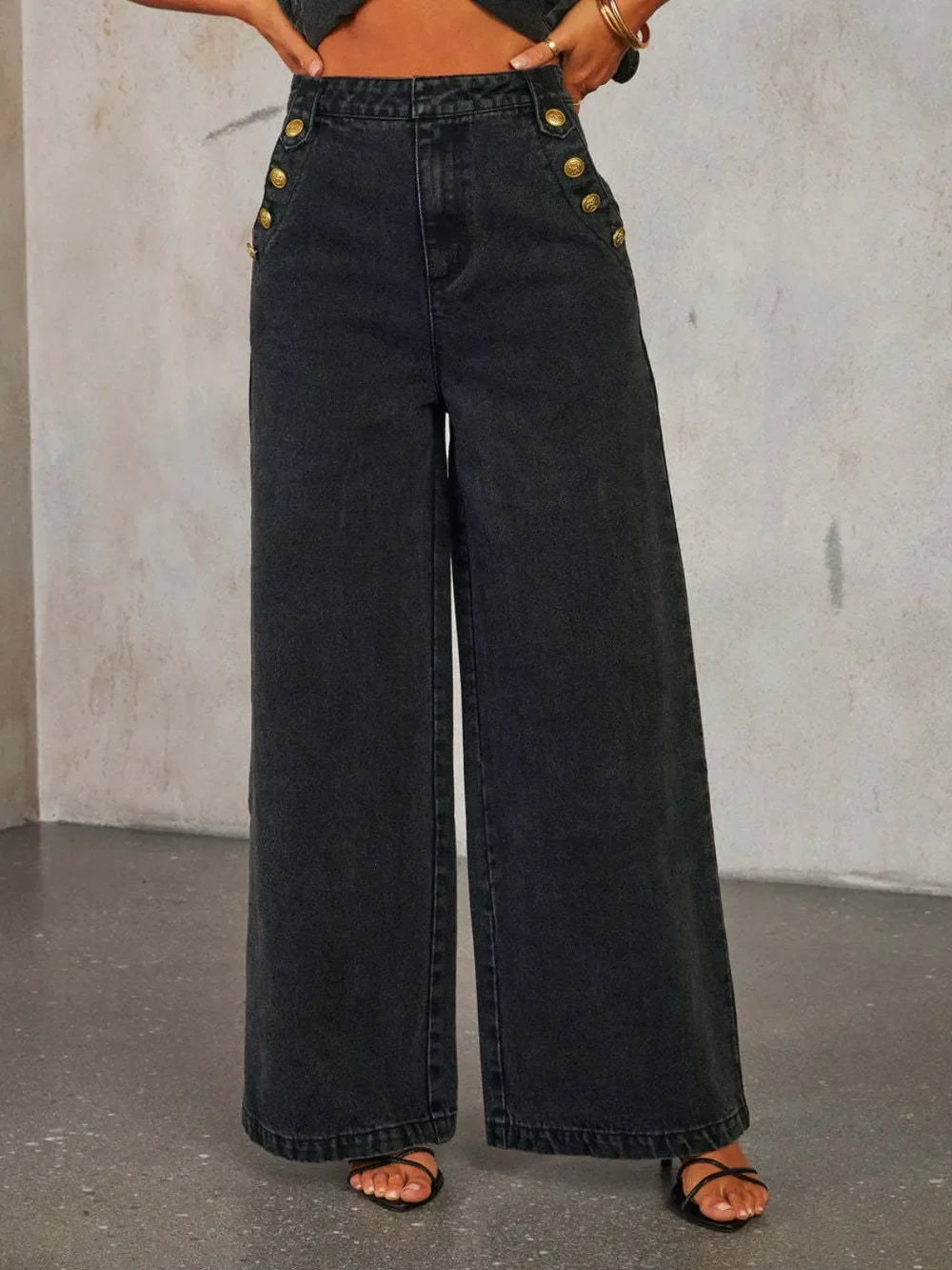 High-waisted wide leg black denim jeans with side gold button details