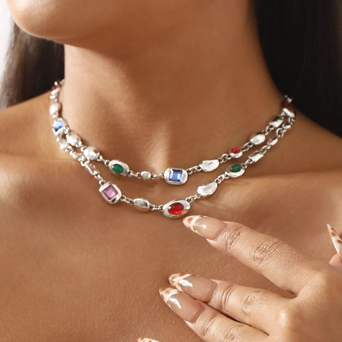 Layered silver necklace with colorful gemstones and pearl accents, perfect for elegant everyday wear