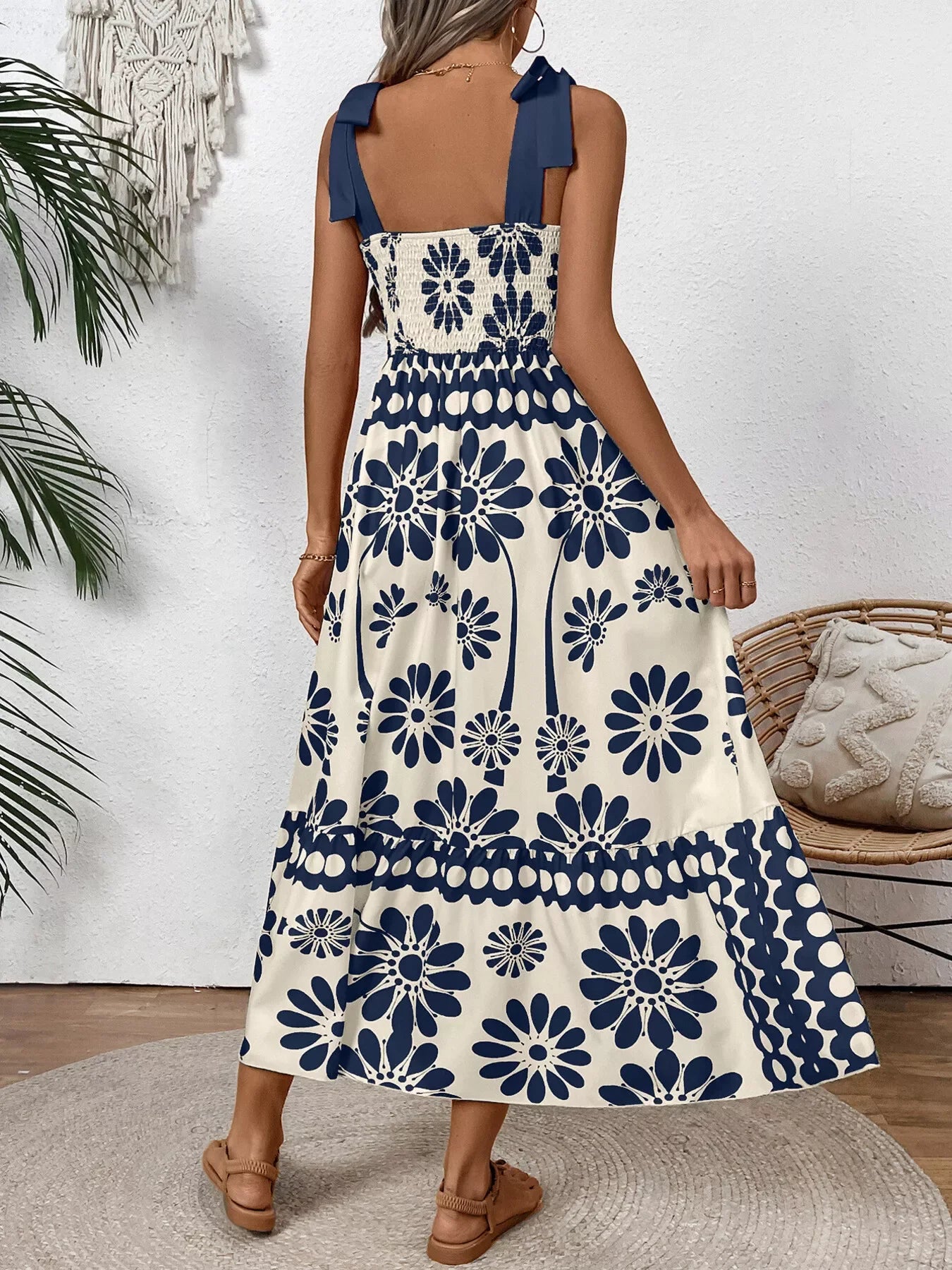 Blue floral print midi dress with bow straps, smocked back, and tiered skirt for summer elegance