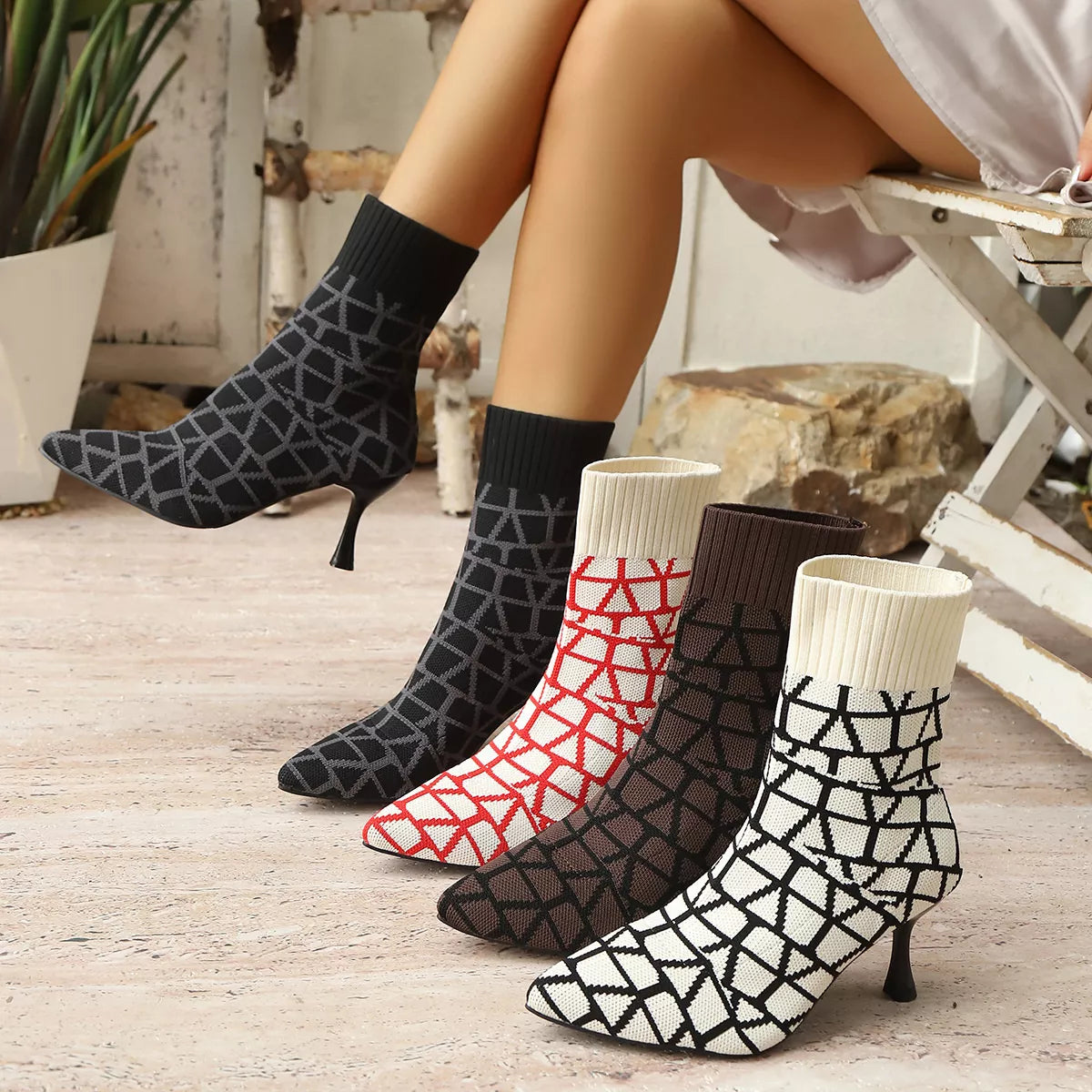 Women's geometric knit sock boots in black, red, brown, and white with kitten heels