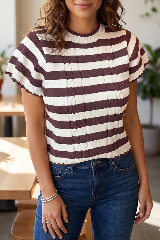 Woman wearing an Evie's Dreamland burgundy and white striped cable-knit short sleeve sweater and blue jeans.