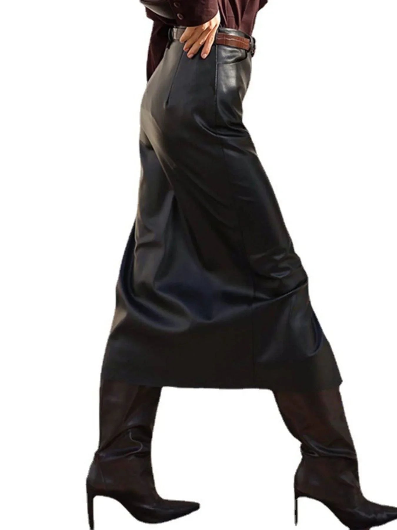 Woman in black faux leather midi skirt and pointed toe high heeled boots