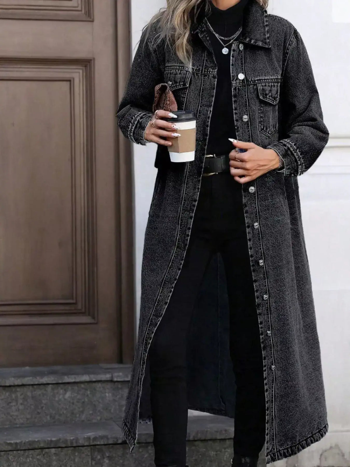 Woman wearing a charcoal grey longline denim jacket by Evie's Dreamland over a black turtleneck and pants.