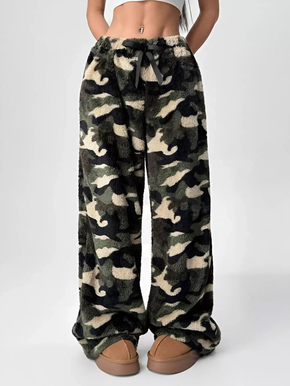 Women's cozy camo fleece lounge pants with drawstring waistband and wide legs styled with brown slippers