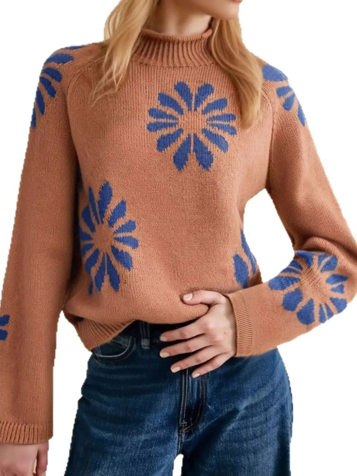 Brown Evie's Dreamland mock neck raglan sleeve sweater with blue flower patterns, paired with blue jeans.