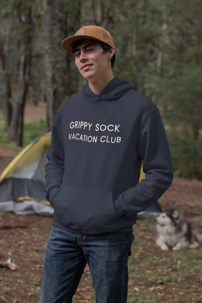 Lifestyle image of person wearing Grippy Sock Vacation Club Hoodie outdoors.