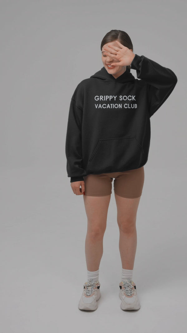 Cozy unisex Grippy Sock Vacation Club Hoodie displayed on a model.