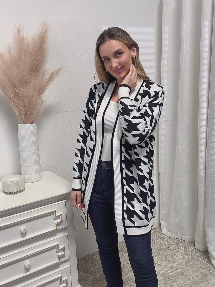 Flat lay of houndstooth knit cardigan with accessories for chic fall fashion outfit.