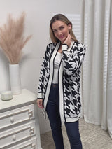 Flat lay of houndstooth knit cardigan with accessories for chic fall fashion outfit.